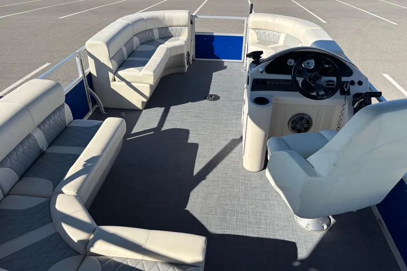 Slide: The Image of 2023 Lexington 321 Fish pontoon boat interior with plush seating and steering console. - 7