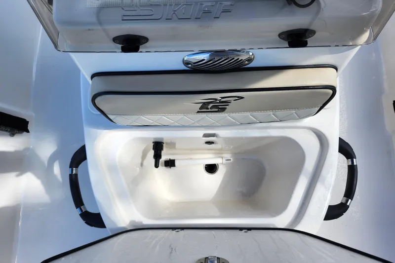 Slide: The Image of 2022 Carolina Skiff 178 JLS boat interior with storage compartment and seating. - 15