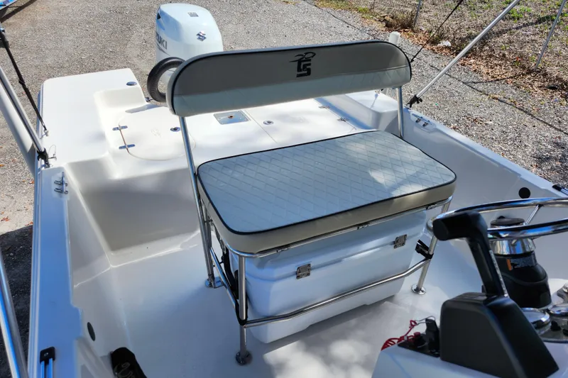 Slide: The Image of 2022 Carolina Skiff 178 JLS boat interior with seating and Suzuki outboard motor. - 19
