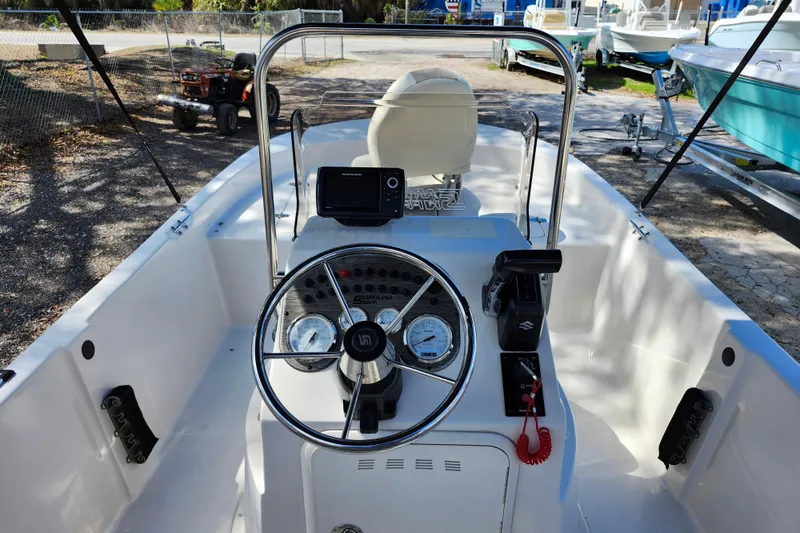 Slide: The Image of 2022 Carolina Skiff 178 JLS boat interior with steering wheel and control panel. - 21