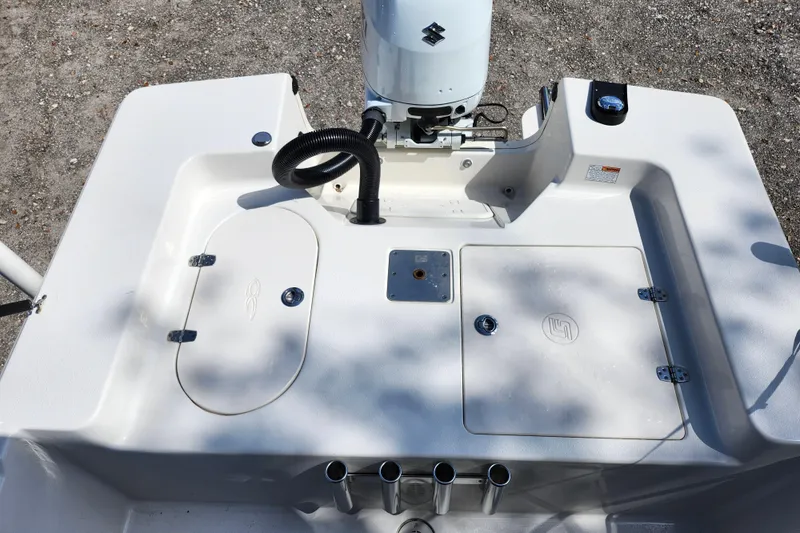 Slide: The Image of 2022 Carolina Skiff 178 JLS boat deck with storage compartments and motor. - 24