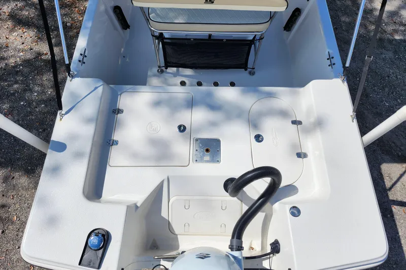 Slide: The Image of 2022 Carolina Skiff 178 JLS boat deck with storage compartments and seating. - 28