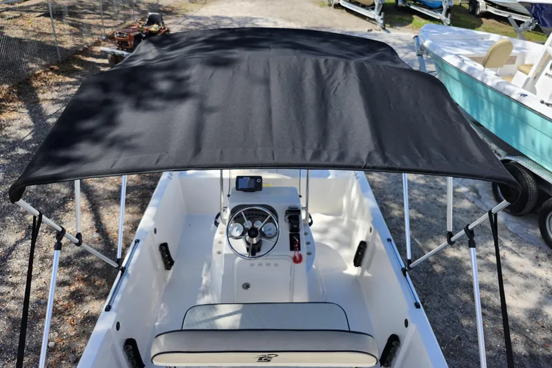 Slide: The Image of 2022 Carolina Skiff 178 JLS boat with black canopy and steering console. - 30