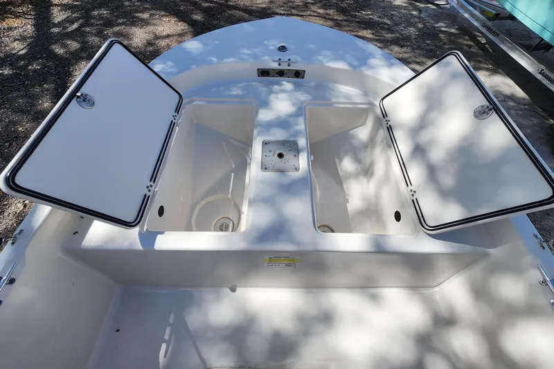 Slide: The Image of 2022 Carolina Skiff 178 JLS boat storage compartments open, showcasing interior space. - 34