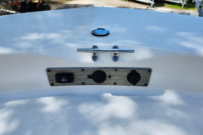 Slide: The Image of 2022 Carolina Skiff 178 JLS boat dashboard with switches and cleat. - 36