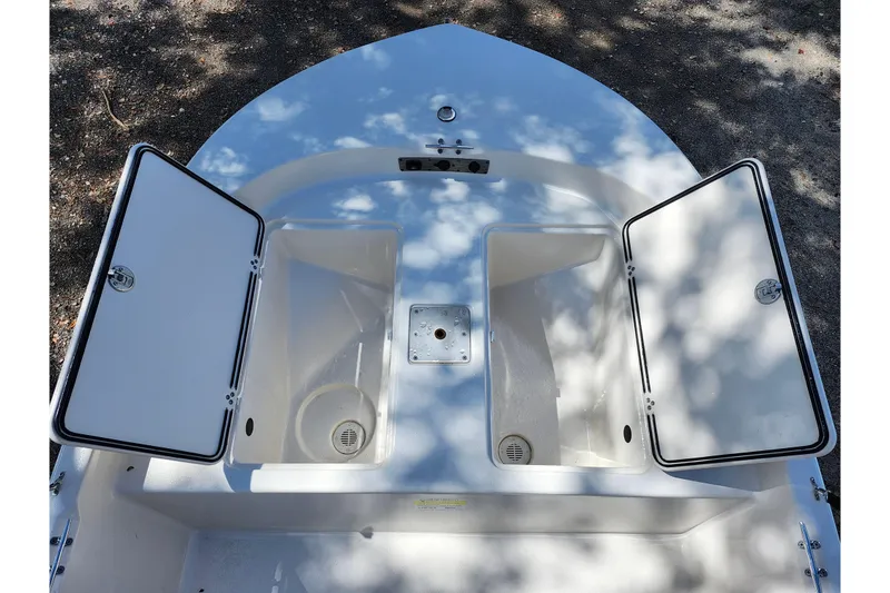 Slide: The Image of 2022 Carolina Skiff 178 JLS boat storage compartments open, showing interior details. - 37