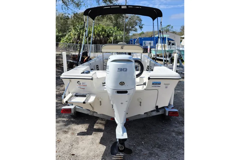 Slide: The Image of 2022 Carolina Skiff 178 JLS boat with Suzuki 90 outboard motor, parked outdoors. - 5