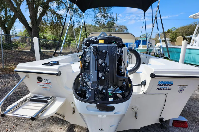 Slide: The Image of 2022 Carolina Skiff 178 JLS boat with outboard motor, docked outdoors. - 9
