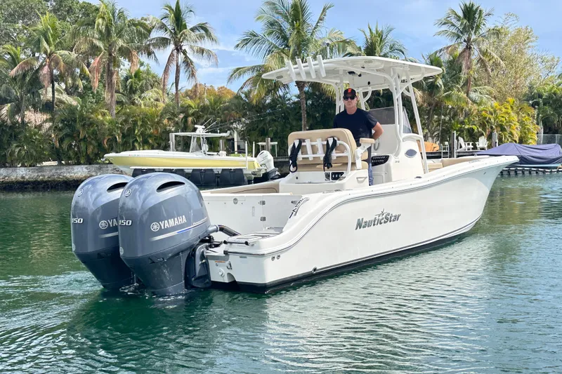 Slide: The Image of 2020 NauticStar 25 XS boat with dual Yamaha engines on a tropical waterway. - 30