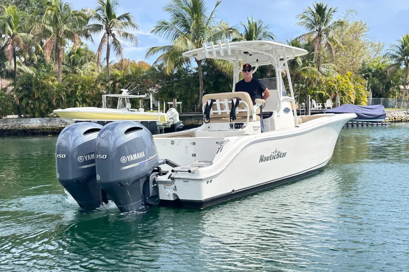 Slide: The Image of 2020 NauticStar 25 XS boat with dual Yamaha engines on a tropical waterway. - 31