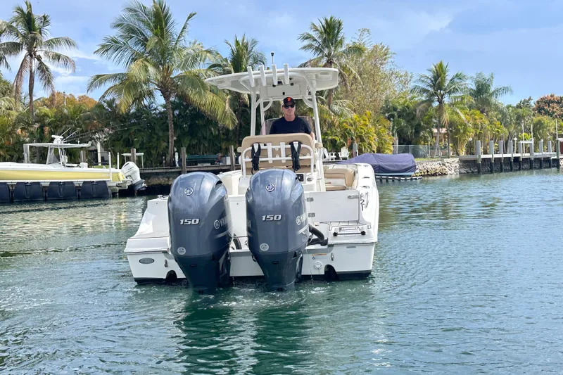 Slide: The Image of 2020 NauticStar 25 XS boat with dual Yamaha engines on a tropical waterway. - 34