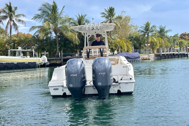 Slide: The Image of 2020 NauticStar 25 XS boat with dual Yamaha engines on a scenic waterway. - 35