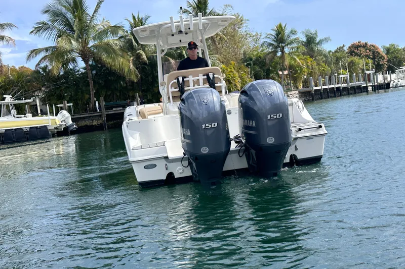 Slide: The Image of 2020 NauticStar 25 XS boat with twin Yamaha 150 engines on a scenic waterway. - 36