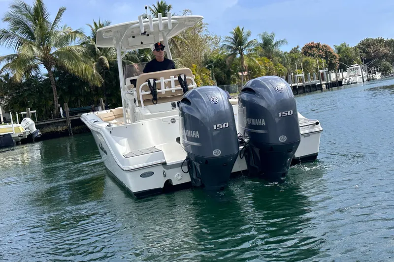 Slide: The Image of 2020 NauticStar 25 XS boat with twin Yamaha 150 engines on a scenic waterway. - 38