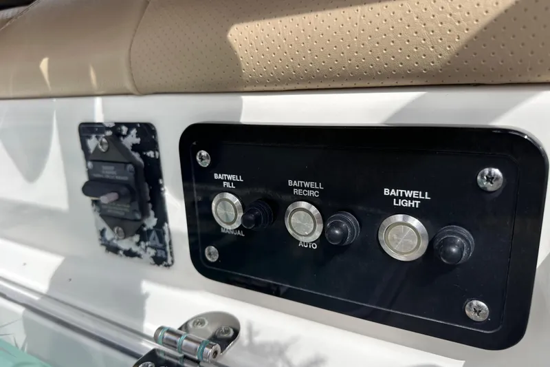 Slide: The Image of Control panel of a 2020 NauticStar 25 XS boat, featuring baitwell switches. - 40