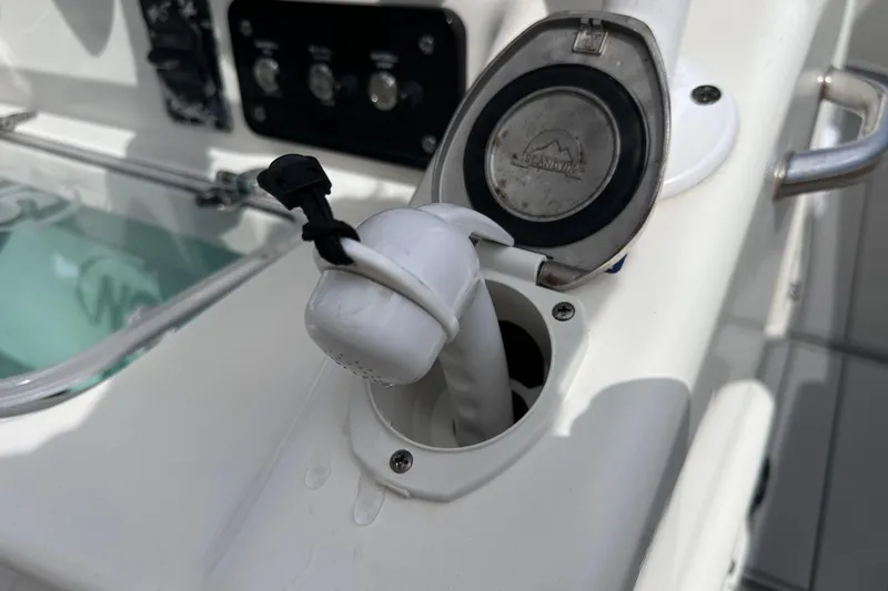 Slide: The Image of 2020 NauticStar 25 XS boat detail showing a fuel cap and control panel. - 42