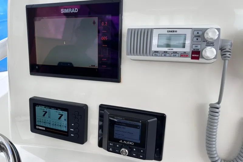 Slide: The Image of Control panel of 2020 NauticStar 25 XS boat with Simrad, Uniden, Yamaha, and JL Audio devices. - 44