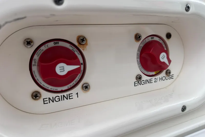Slide: The Image of 2020 NauticStar 25 XS engine controls with red switches labeled "Engine 1" and "Engine 2/House". - 53