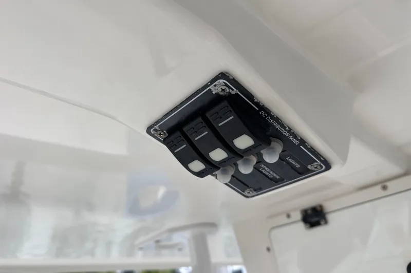 Slide: The Image of Control panel on 2020 NauticStar 25 XS boat, featuring labeled switches. - 57