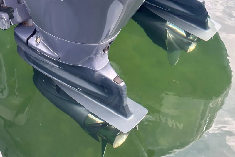 Slide: The Image of Outboard motors of a 2020 NauticStar 25 XS boat in water. - 63