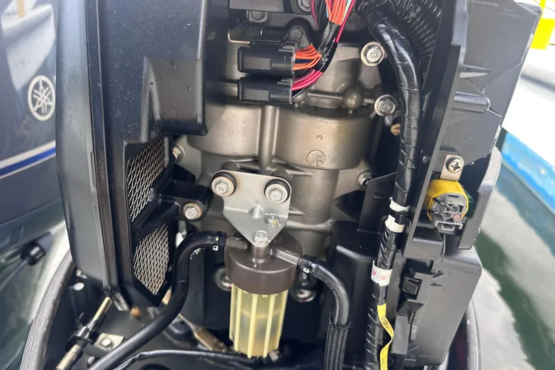 Slide: The Image of 2020 NauticStar 25 XS boat engine close-up, showcasing internal components and wiring. - 69