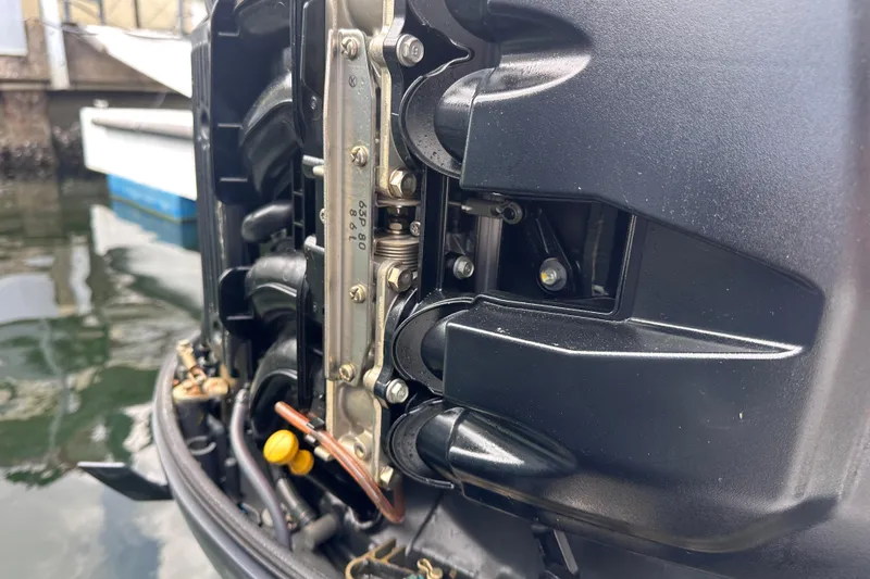 Slide: The Image of Close-up of a 2020 NauticStar 25 XS boat engine near water. - 70
