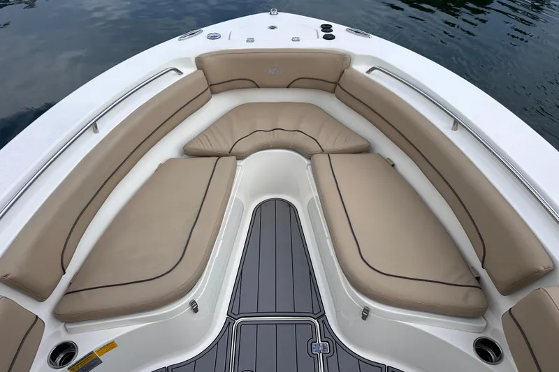 Slide: The Image of 2020 NauticStar 25 XS boat interior with tan cushioned seating and sleek design. - 76