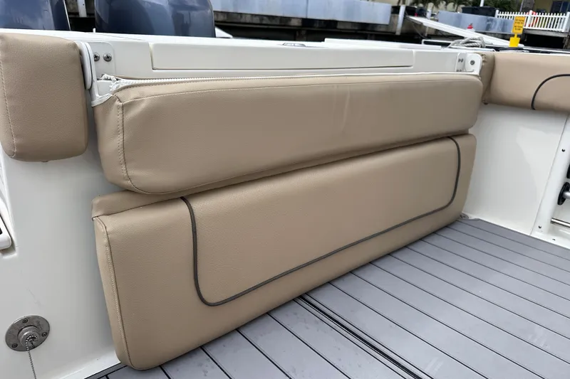 Slide: The Image of 2020 NauticStar 25 XS boat with beige cushioned seating on deck. - 79