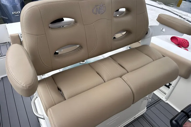 Slide: The Image of 2020 NauticStar 25 XS boat seat with tan upholstery and armrests. - 80