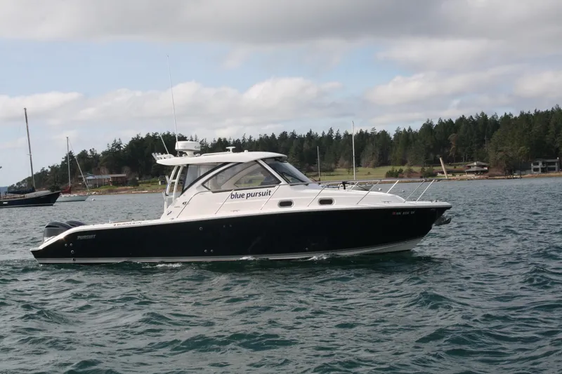 The Image of 2016 Pursuit OS 325 Offshore boat cruising on a scenic waterway. - 0