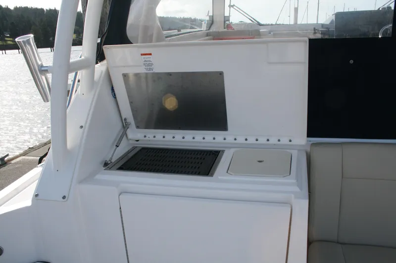 Slide: The Image of 2016 Pursuit OS 325 Offshore boat interior with seating and utility area. - 10