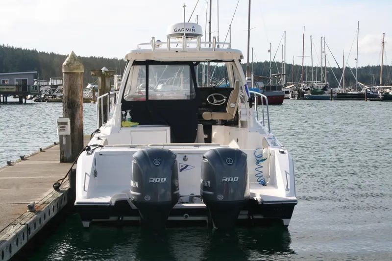 Slide: The Image of 2016 Pursuit OS 325 Offshore boat docked with twin Yamaha 300 engines. - 20