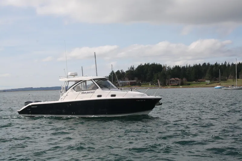 Slide: The Image of 2016 Pursuit OS 325 Offshore boat cruising on a scenic lake. - 3