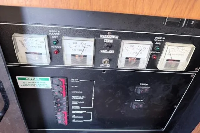 Slide: The Image of Electrical control panel of a 1998 Carver 370 Voyager boat with voltage meters. - 12