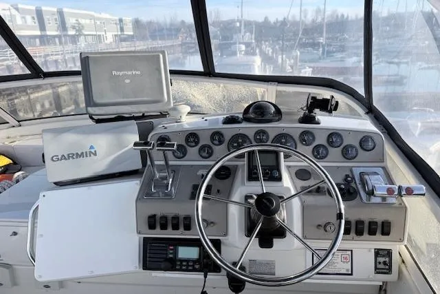 Slide: The Image of 1998 Carver 370 Voyager helm with Garmin and Raymarine navigation systems. - 13