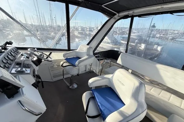Slide: The Image of Interior of 1998 Carver 370 Voyager yacht with helm and seating area. - 14