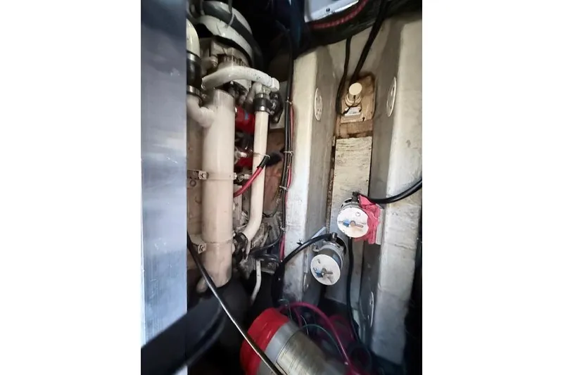 Slide: The Image of Engine compartment of a 1998 Carver 370 Voyager boat, showcasing mechanical components and wiring. - 17