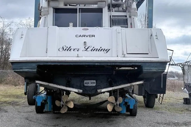 Slide: The Image of 1998 Carver 370 Voyager "Silver Lining" yacht on land, rear view with propellers visible. - 19