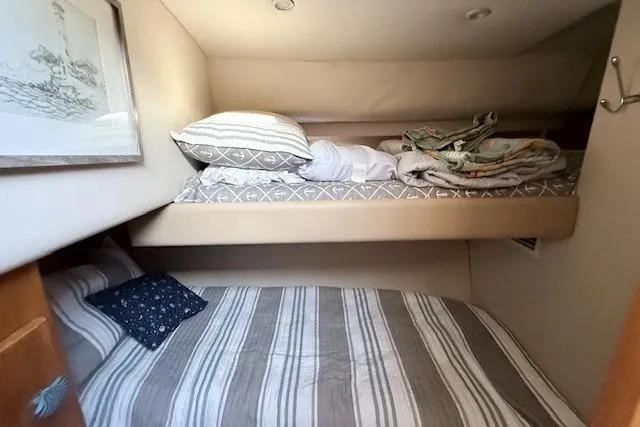 Slide: The Image of 1998 Carver 370 Voyager cabin with cozy bunk beds and nautical decor. - 4