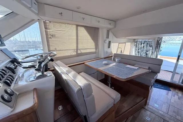 Slide: The Image of Interior of 1998 Carver 370 Voyager yacht with dining area and helm station. - 6