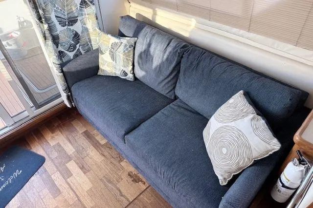 Slide: The Image of Gray sofa with patterned cushions inside a 1998 Carver 370 Voyager boat cabin. - 8