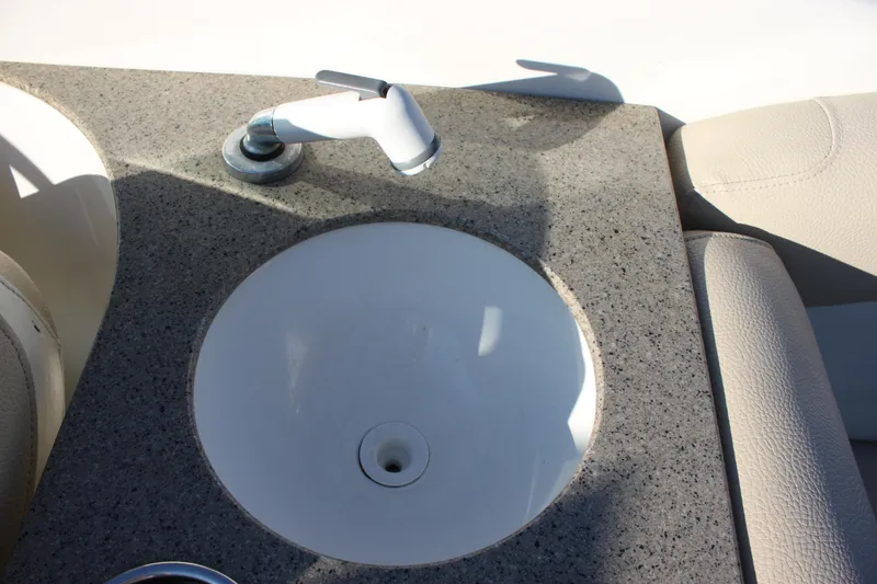 Slide: The Image of 2018 NauticStar 243DC Sport Deck boat sink with granite countertop. - 14