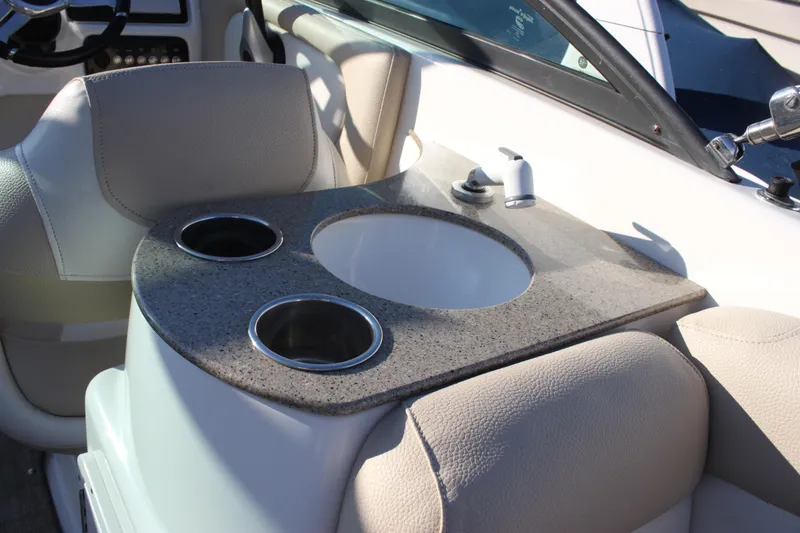 Slide: The Image of 2018 NauticStar 243DC Sport Deck interior with sink and cup holders. - 15