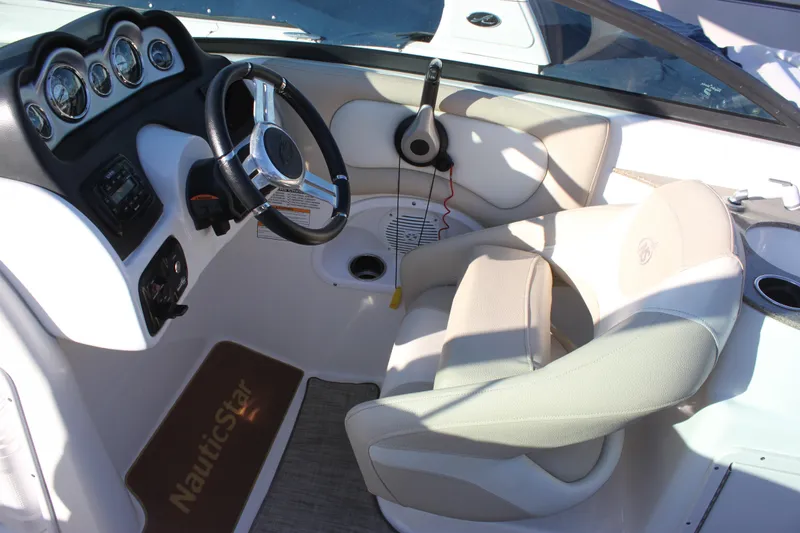 Slide: The Image of 2018 NauticStar 243DC Sport Deck boat interior with steering wheel and dashboard controls. - 4