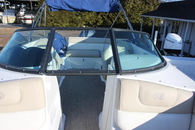 Slide: The Image of 2018 NauticStar 243DC Sport Deck boat interior with seating and windshield. - 10