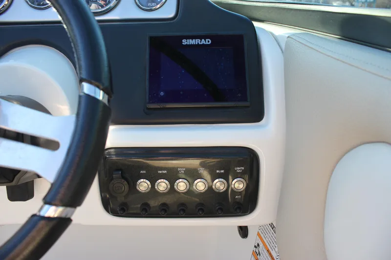 Slide: The Image of 2018 NauticStar 243DC Sport Deck dashboard with Simrad display and control panel. - 16