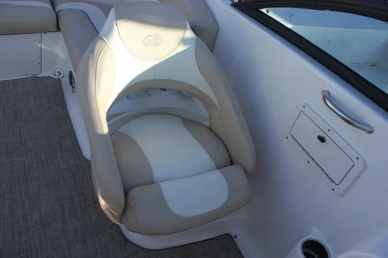 Slide: The Image of 2018 NauticStar 243DC Sport Deck boat seat with beige and white upholstery. - 18