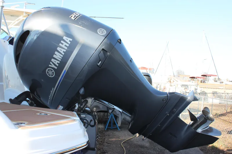 Slide: The Image of 2018 NauticStar 243DC Sport Deck with Yamaha outboard motor, docked in a marina. - 19