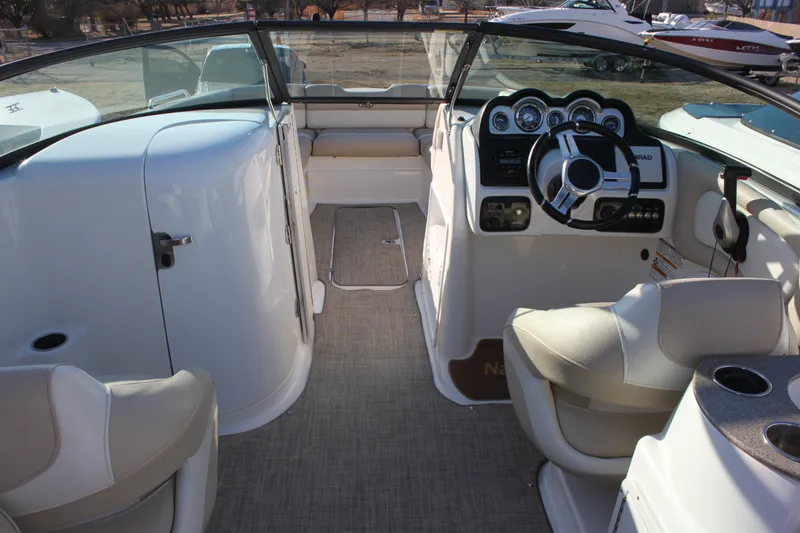 Slide: The Image of 2018 NauticStar 243DC Sport Deck interior with steering wheel and seating. - 3