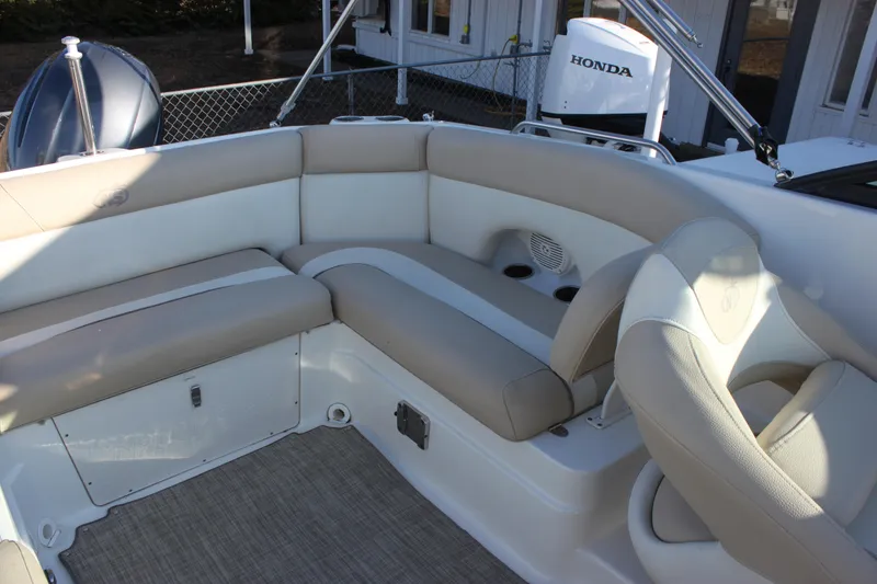 Slide: The Image of 2018 NauticStar 243DC Sport Deck boat interior with beige seating and Honda engine. - 6